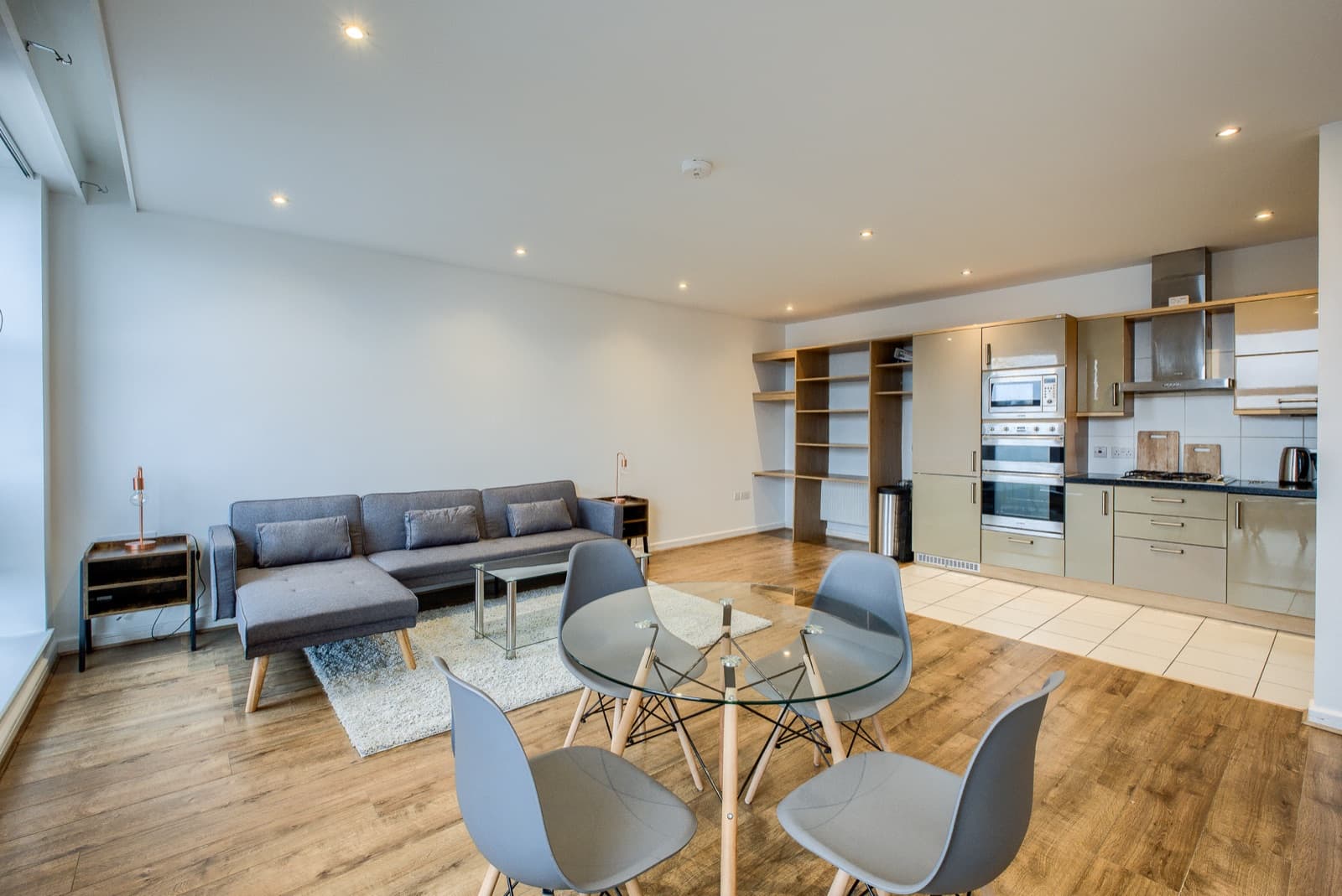 The open-plan living room and kitchen of the Leamington flat, bright and newly furnished